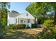 Charming white home featuring a well-manicured lawn, a quaint front porch, and the American flag at 115 Peachtree St, Charleston, SC 29403