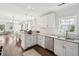 Modern kitchen featuring white cabinets, stainless steel appliances, granite countertops, and an open floor plan at 115 Peachtree St, Charleston, SC 29403
