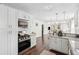 Well-lit kitchen featuring white cabinets, stainless steel appliances, and granite countertops with backyard views at 115 Peachtree St, Charleston, SC 29403