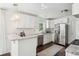 Contemporary kitchen featuring stainless steel appliances, white cabinets, granite countertops, and stylish lighting at 115 Peachtree St, Charleston, SC 29403