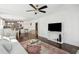 Well-lit living room featuring hardwood floors, a comfortable sofa, and an open view into the dining area at 115 Peachtree St, Charleston, SC 29403