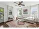 Bright living room with hardwood floors, large windows, and a comfortable sofa, ideal for relaxation at 115 Peachtree St, Charleston, SC 29403
