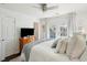Well-lit bedroom featuring a bed with cozy throw, wood dresser, and French doors to outdoor living space at 115 Peachtree St, Charleston, SC 29403