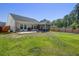 Back exterior with backyard, patio, and screened in porch at 117 Camellia Bloom Dr, Moncks Corner, SC 29461