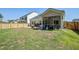 Back exterior with backyard, patio, and screened in porch, and fenced yard at 117 Camellia Bloom Dr, Moncks Corner, SC 29461