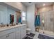 Modern bathroom with double sinks, tiled shower, and walk-in closet at 117 Camellia Bloom Dr, Moncks Corner, SC 29461