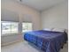 Bright bedroom with two large windows and a blue plaid comforter at 117 Camellia Bloom Dr, Moncks Corner, SC 29461