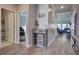 Hallway features wood-look flooring, a hall table and view to a living room and additional rooms at 117 Camellia Bloom Dr, Moncks Corner, SC 29461