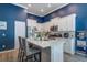 Modern kitchen with stainless steel appliances, a stylish island, and a contrasting dark blue accent wall at 117 Camellia Bloom Dr, Moncks Corner, SC 29461