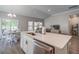 Open kitchen with island, stainless steel appliances, gray walls, and eat-in area at 117 Camellia Bloom Dr, Moncks Corner, SC 29461
