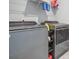 Laundry room features gray washer and dryer with wire shelving at 117 Camellia Bloom Dr, Moncks Corner, SC 29461