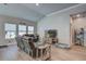 Comfortable living room with ample natural light, vaulted ceilings and wood-look flooring at 117 Camellia Bloom Dr, Moncks Corner, SC 29461