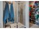 Modern tiled shower with glass door and view into walk-in closet at 117 Camellia Bloom Dr, Moncks Corner, SC 29461