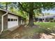 Backyard with a detached garage and a brick house featuring a screened-in porch at 119 Savannah Round, Summerville, SC 29485