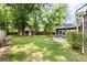 Lush backyard with a storage shed, stone patio, and screened back porch at 119 Savannah Round, Summerville, SC 29485