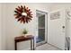 Welcoming entryway featuring light wood flooring, a modern sunburst mirror, and an open door at 119 Savannah Round, Summerville, SC 29485