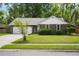 Charming brick home featuring a well-manicured lawn, mature trees, and an attached two-car garage at 119 Savannah Round, Summerville, SC 29485