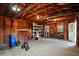 Garage featuring wooden wall supports, shelves, a work bench and an open door to the outside at 119 Savannah Round, Summerville, SC 29485