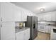 Modern kitchen featuring white cabinetry, stainless steel appliances, and granite countertops, blending style and functionality at 119 Savannah Round, Summerville, SC 29485