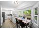 Bright kitchen with white cabinets, stainless steel appliances, and a sunlit breakfast nook with backyard views at 119 Savannah Round, Summerville, SC 29485