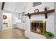 Bright living room with vaulted ceiling, fireplace with brick surround and decorative mantel, and hardwood floors at 119 Savannah Round, Summerville, SC 29485