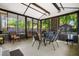 Enclosed sunroom with natural lighting, various seating arrangements, and brick accent wall at 119 Savannah Round, Summerville, SC 29485