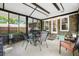 Outdoor patio featuring multiple seating arrangements, brick foundation, and natural lighting at 119 Savannah Round, Summerville, SC 29485
