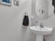 Neat powder room with a pedestal sink and modern fixtures and decorative elements at 122 Brockman Way, Goose Creek, SC 29445