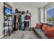 Bright dressing room with expansive wardrobe rack, television, and comfortable seating at 122 Brockman Way, Goose Creek, SC 29445