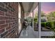 Inviting front porch with brick accents, offering a cozy outdoor seating area at 122 Brockman Way, Goose Creek, SC 29445