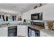 Well-lit kitchen with white cabinetry and a black appliance suite adjacent to dining area at 122 Brockman Way, Goose Creek, SC 29445