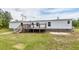 Exterior view of backyard with wooden deck and white siding on the manufactured home at 1330 Whitehouse Rd, Summerville, SC 29486