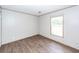 Light-filled bedroom with hardwood flooring, neutral walls, and a large window at 1330 Whitehouse Rd, Summerville, SC 29486