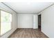 A simple bedroom with wood-look flooring, neutral walls, and natural light at 1330 Whitehouse Rd, Summerville, SC 29486