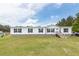 Charming single-story home featuring white siding, black shutters, and a well-maintained front lawn at 1330 Whitehouse Rd, Summerville, SC 29486
