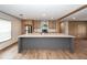 Modern kitchen featuring a gray island, stainless steel appliances, and stylish wood cabinetry, with open living concept at 1330 Whitehouse Rd, Summerville, SC 29486