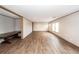 Bright living area featuring wood floors, multiple windows, and seamless connection to the adjacent rooms at 1330 Whitehouse Rd, Summerville, SC 29486