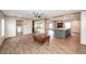 Open-concept living space with a kitchen island, wood-look floors, and lots of natural light at 1330 Whitehouse Rd, Summerville, SC 29486