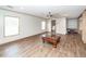 Spacious living room with wood-look floors, a ceiling fan, and natural light from large windows at 1330 Whitehouse Rd, Summerville, SC 29486