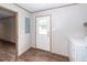 Clean mud room with a back door, washer and dryer hookups, and wood-look floors at 1330 Whitehouse Rd, Summerville, SC 29486