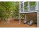 Serene backyard seating area with chairs surrounded by lush foliage and beautiful landscaping at 1500 Trumpet Vine Ct, Mount Pleasant, SC 29464