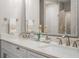 Bathroom vanity with double sinks, a framed mirror, and decorative towels and accessories at 1500 Trumpet Vine Ct, Mount Pleasant, SC 29464
