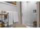 Close-up of bathroom amenities, including toiletry items, shower with tiled walls, and glass door at 1500 Trumpet Vine Ct, Mount Pleasant, SC 29464