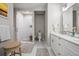 Bright bathroom featuring double vanity, framed mirror, tiled floors, and glass-enclosed shower at 1500 Trumpet Vine Ct, Mount Pleasant, SC 29464