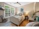 Cozy bedroom featuring a decorative bed, wooden floors, a large window, and ceiling fan at 1500 Trumpet Vine Ct, Mount Pleasant, SC 29464