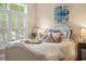 Bedroom with a plush bed, natural light from a window, and classic decor at 1500 Trumpet Vine Ct, Mount Pleasant, SC 29464