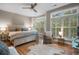 Sunlit bedroom with a large bed, bay window, and cozy chair for relaxation at 1500 Trumpet Vine Ct, Mount Pleasant, SC 29464