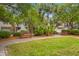 Beautiful townhouse complex featuring well-manicured lawns, mature trees, and charming benches at 1500 Trumpet Vine Ct, Mount Pleasant, SC 29464
