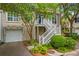 Charming elevated home with inviting white staircase and garage at 1500 Trumpet Vine Ct, Mount Pleasant, SC 29464