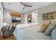 Spacious main bedroom features a ceiling fan, TV, and an open doorway to the ensuite bathroom at 1500 Trumpet Vine Ct, Mount Pleasant, SC 29464